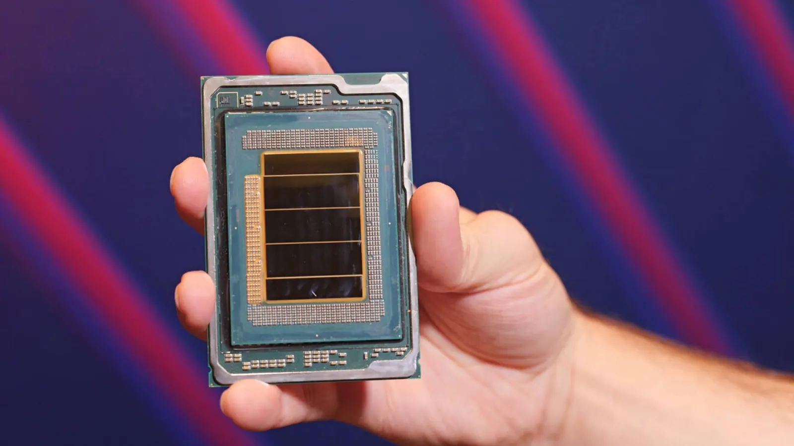 A hand holding a large server processor