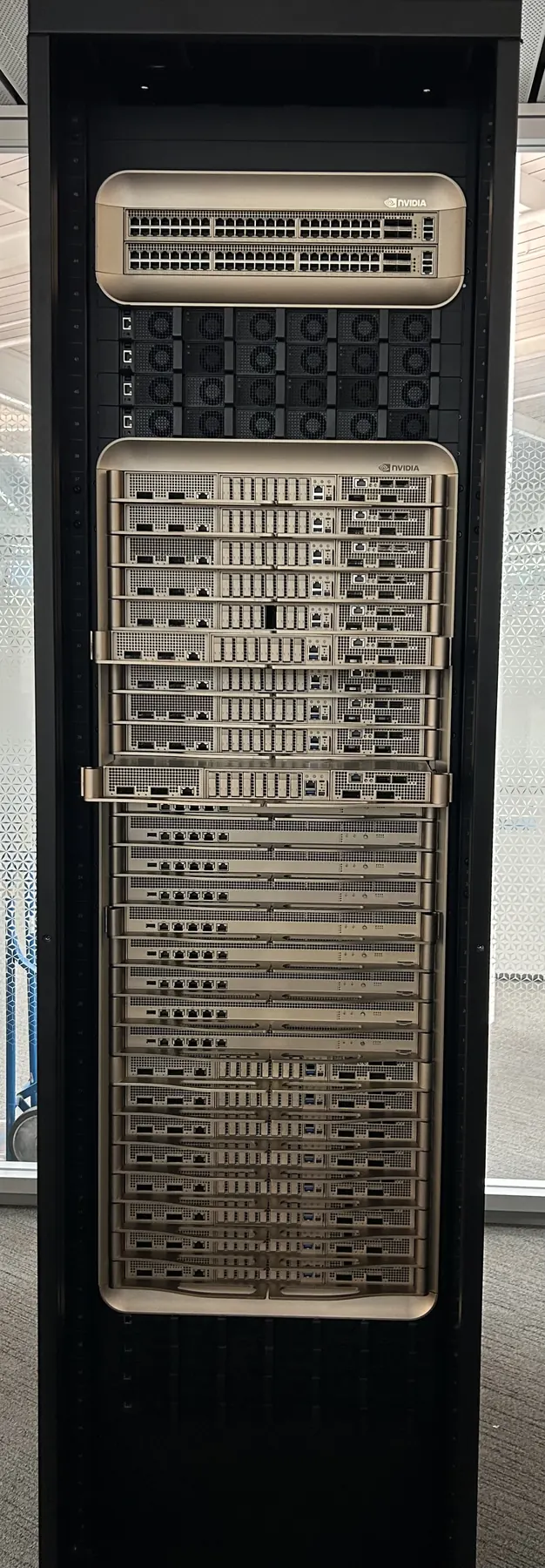 A tall black NVIDIA GB200 rack on display