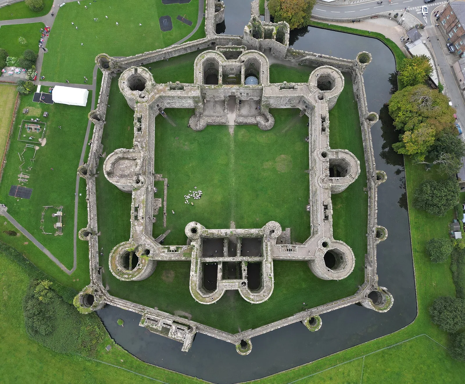 A castle seen from directly above, with two concentric rings of walls and towers inside a water-filled moat
