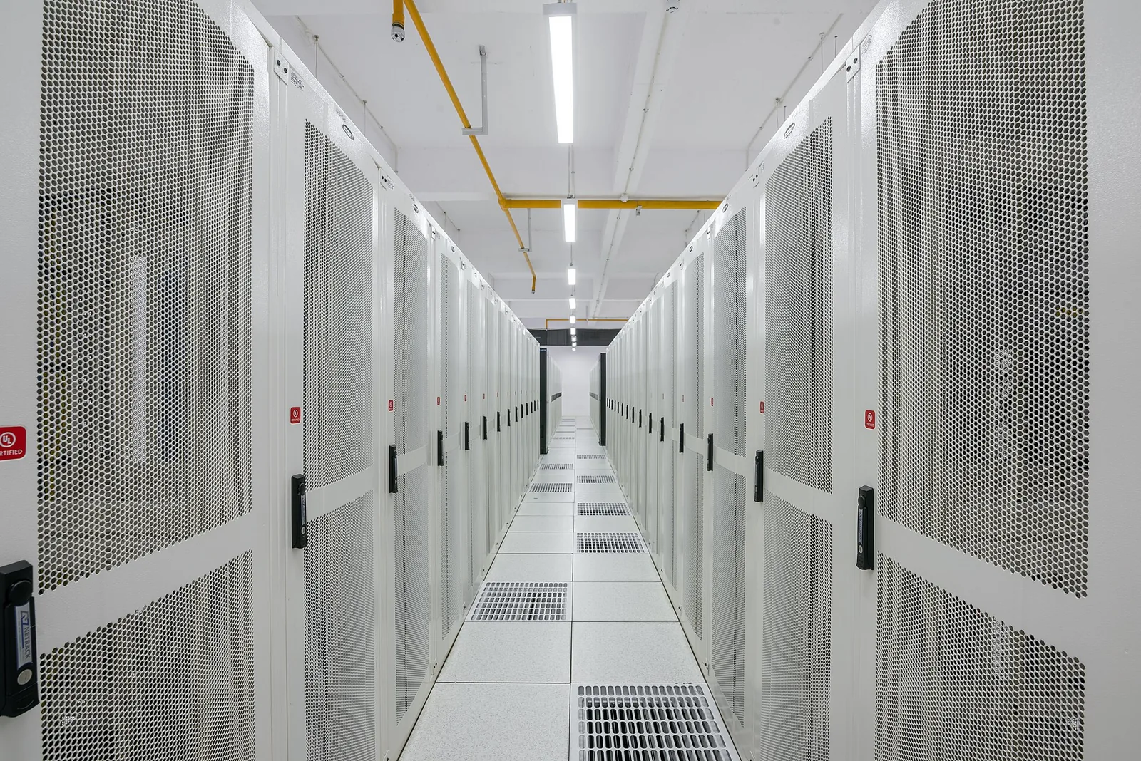 A long cold aisle between two rows of server cabinets