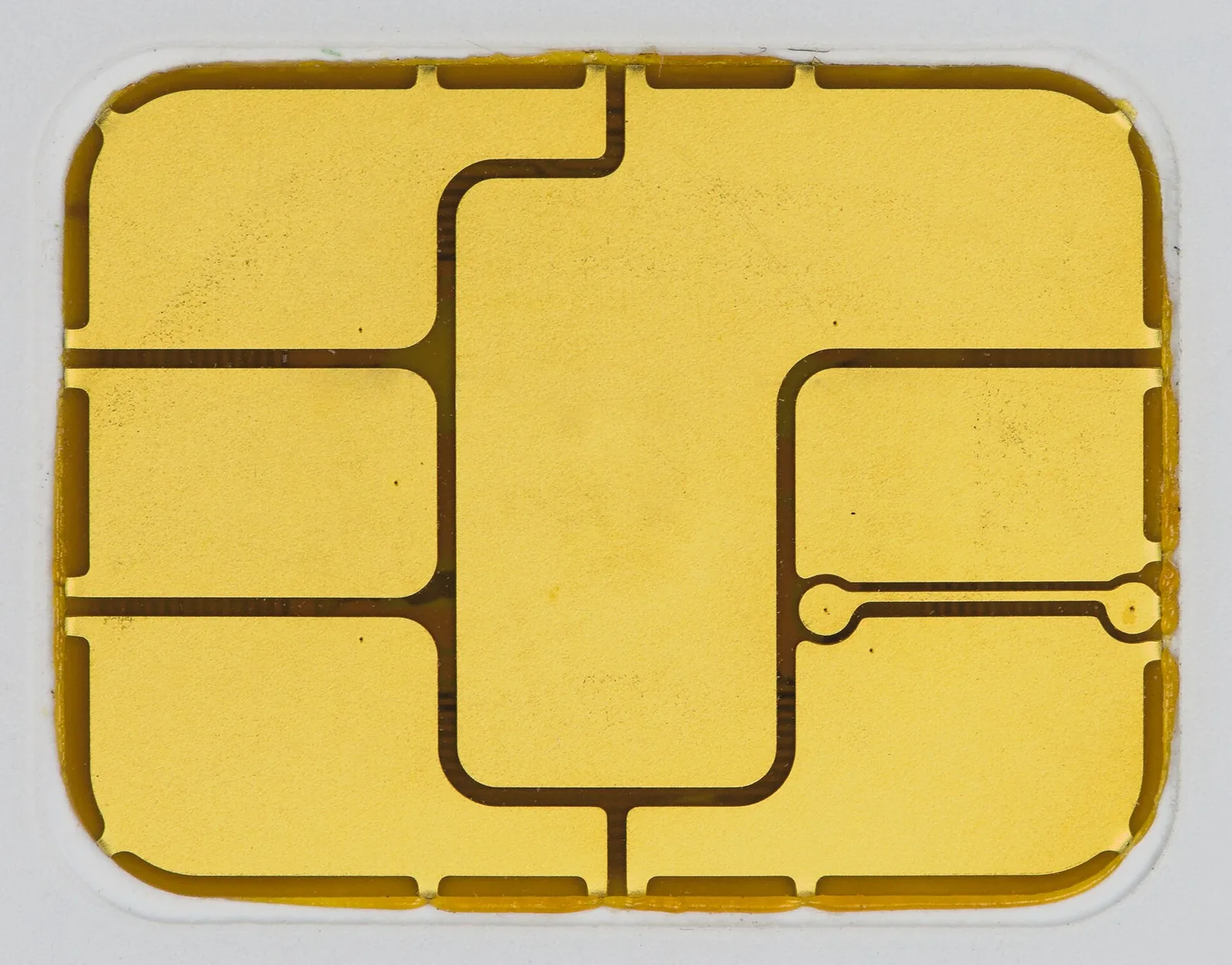 A macro close-up of the gold contact pad of a bank card chip