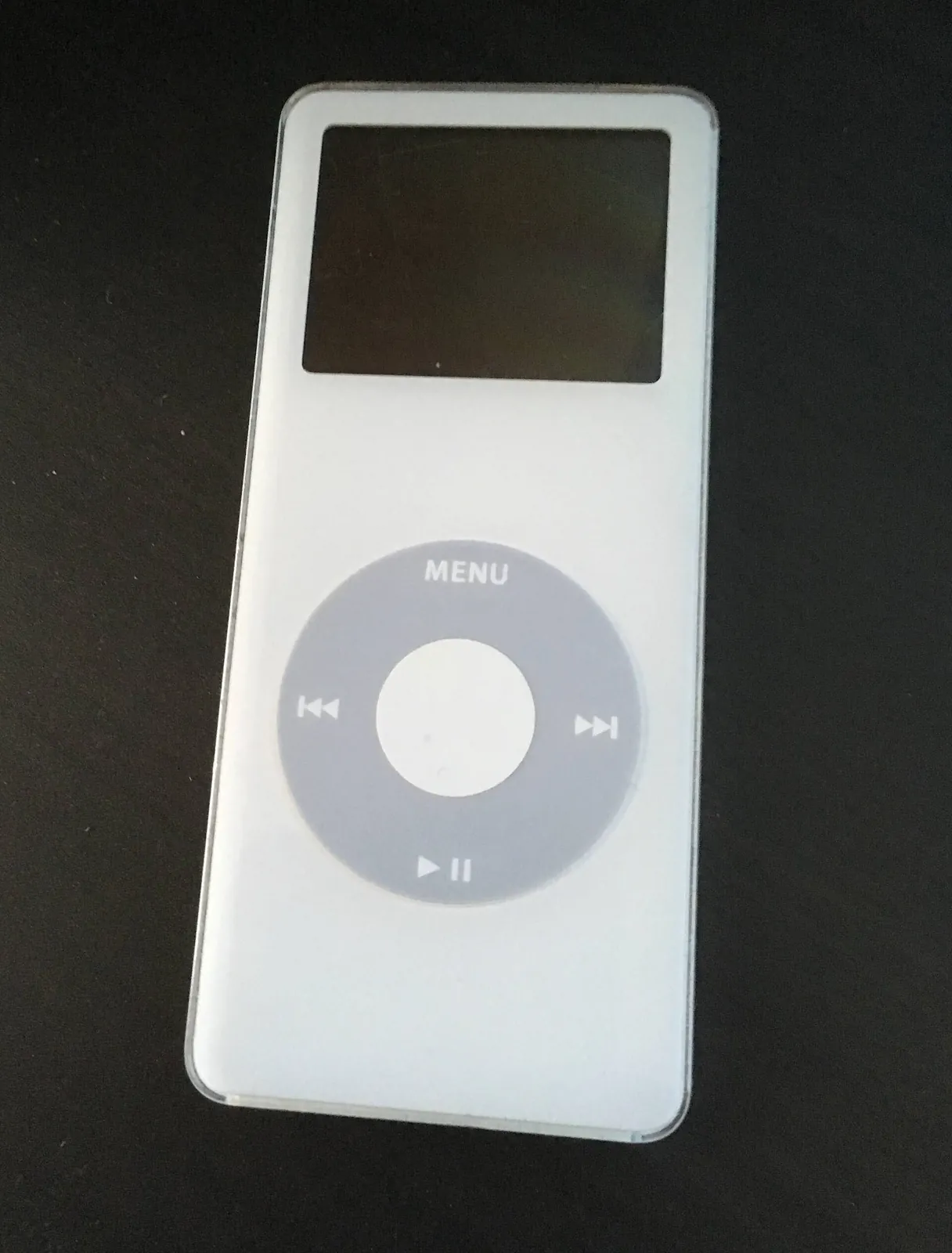 A white first-generation iPod nano on a dark background